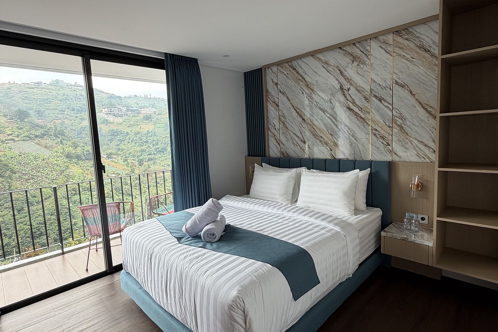 A bedroom with its own balcony above the treetops
