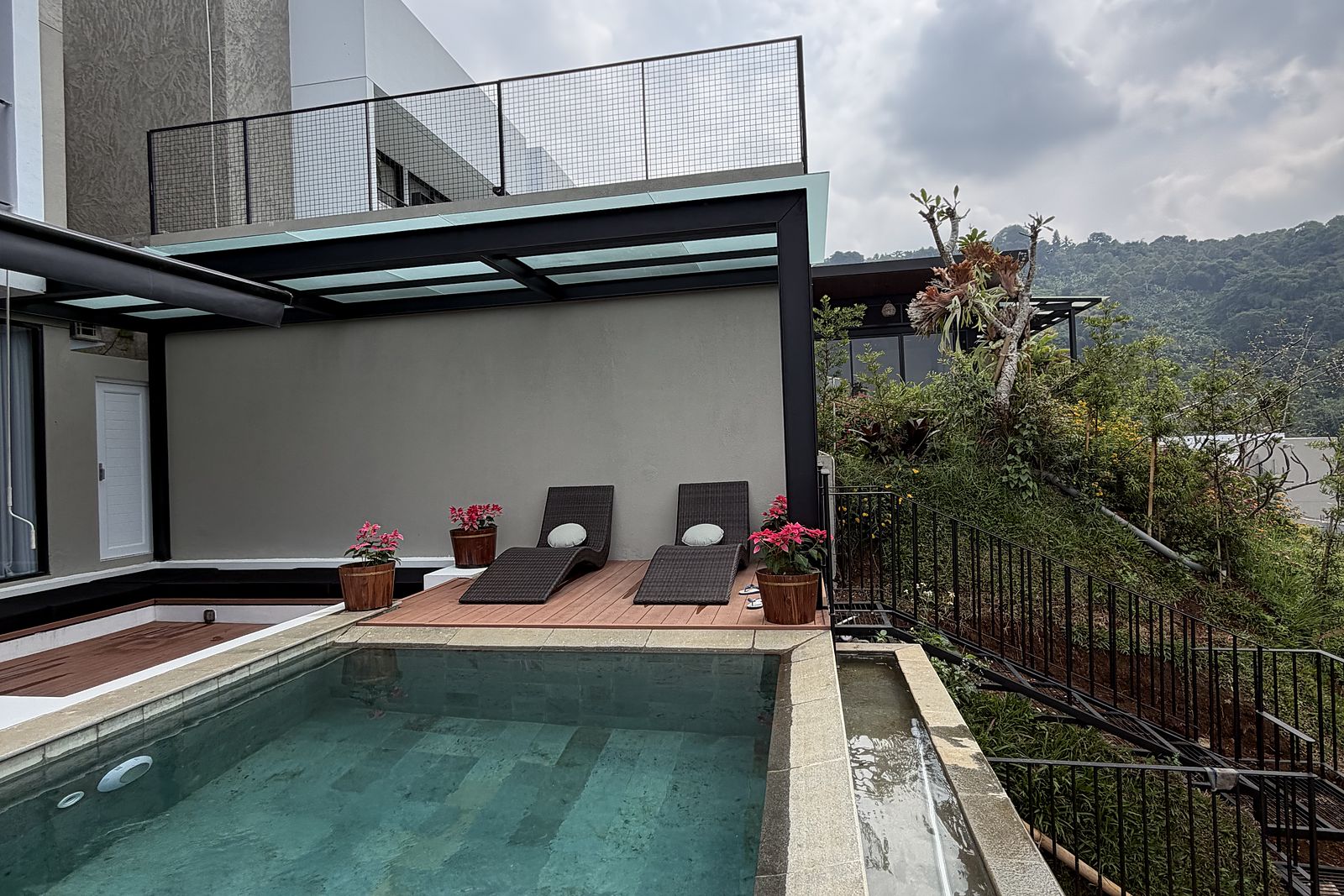 The pool deck looking out over the green valley below